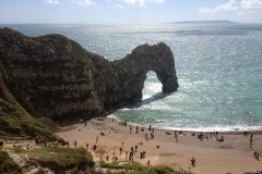 durdle-door-beach-on-a-sunny-day-with-beachgoers-sunbathing-min